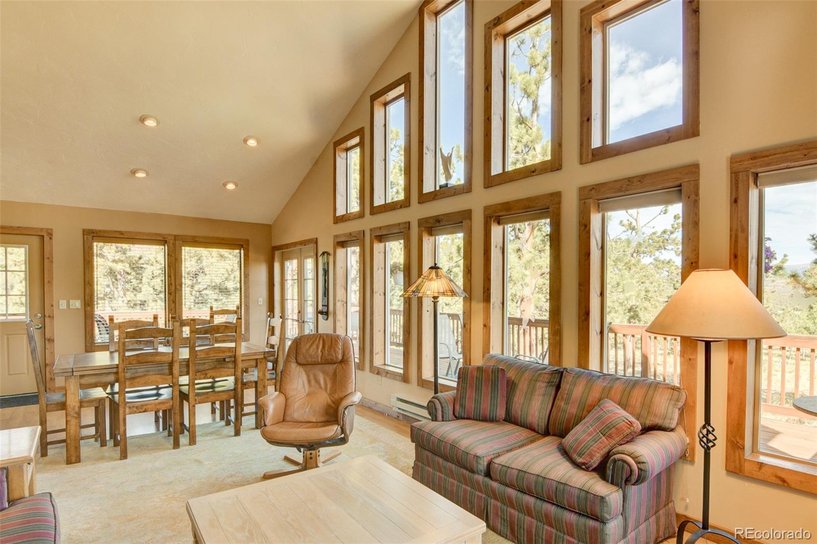 3296 Singletree Road Hartsel, CO 80449 - Photo 20 of 50 a living room with furniture and floor to ceiling windows