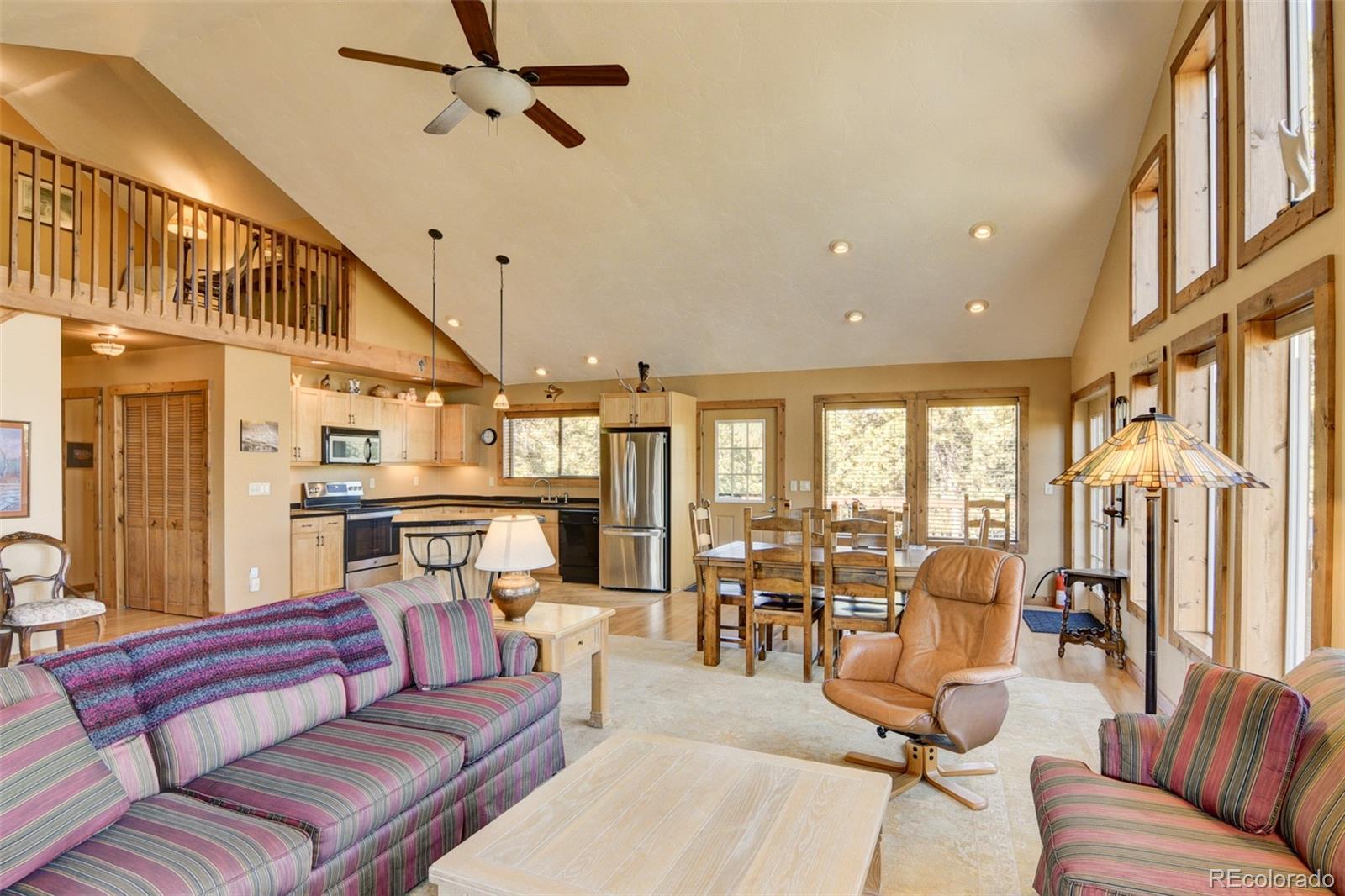 3296 Singletree Road Hartsel, CO 80449 - Photo 21 of 50 a living room with furniture kitchen view and a large window