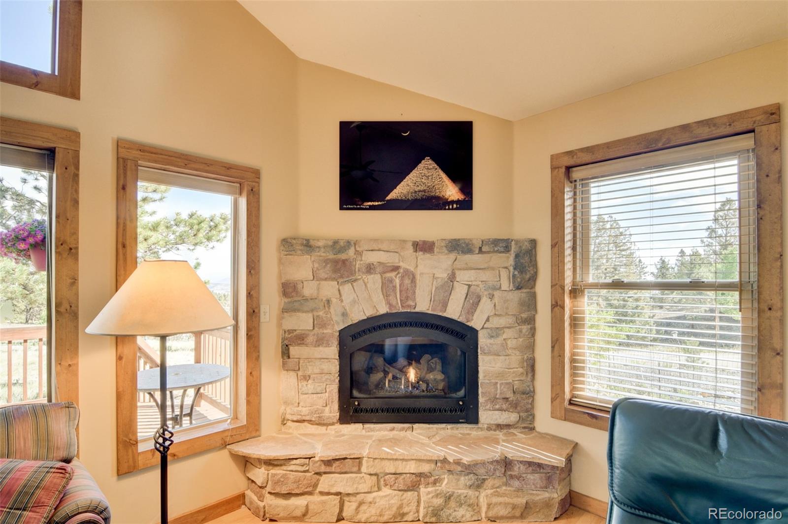3296 Singletree Road Hartsel, CO 80449 - Photo 23 of 50 a living room with furniture and a fireplace