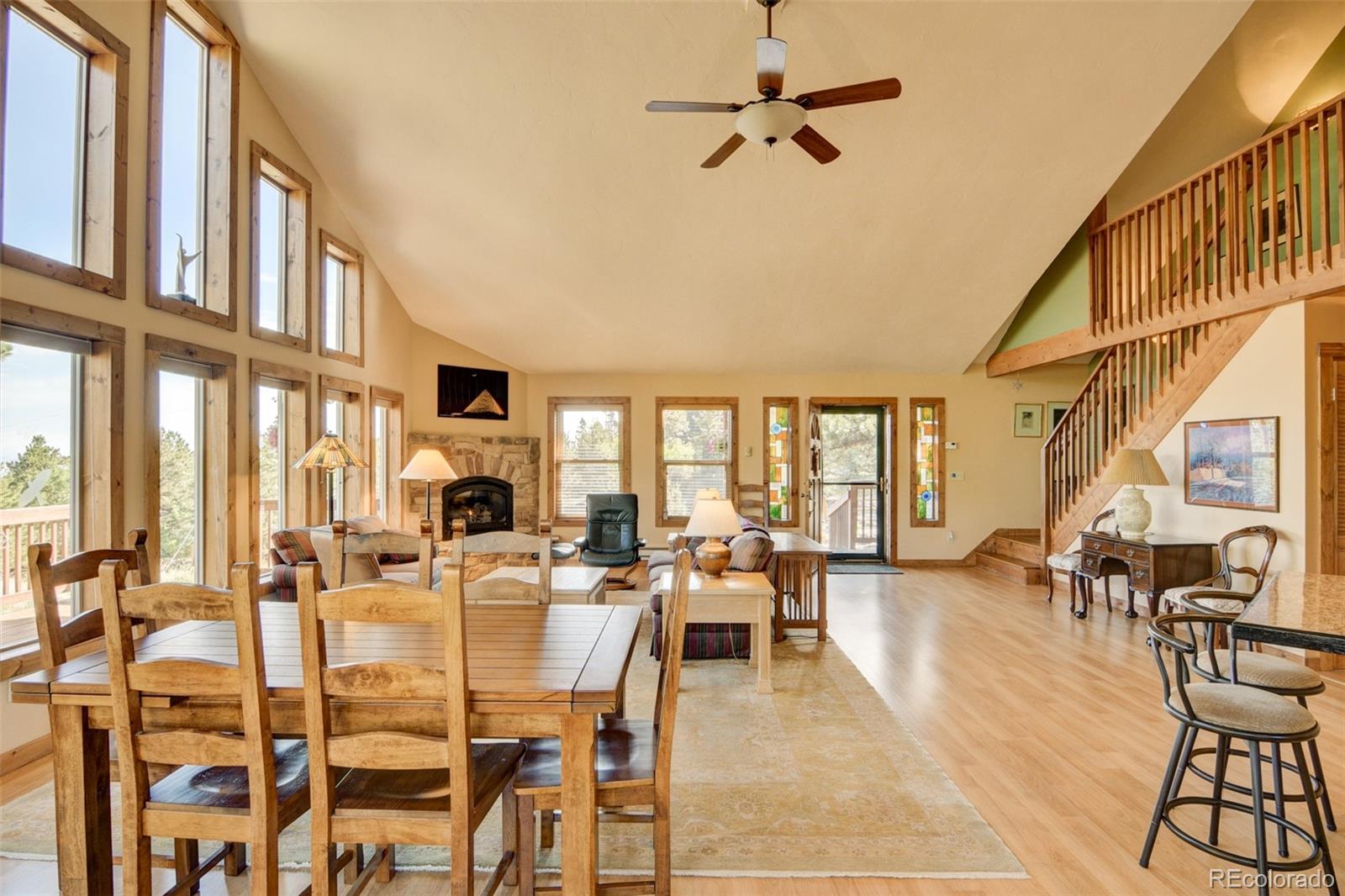 3296 Singletree Road Hartsel, CO 80449 - Photo 24 of 50 a living room with lots of furniture and a chandelier