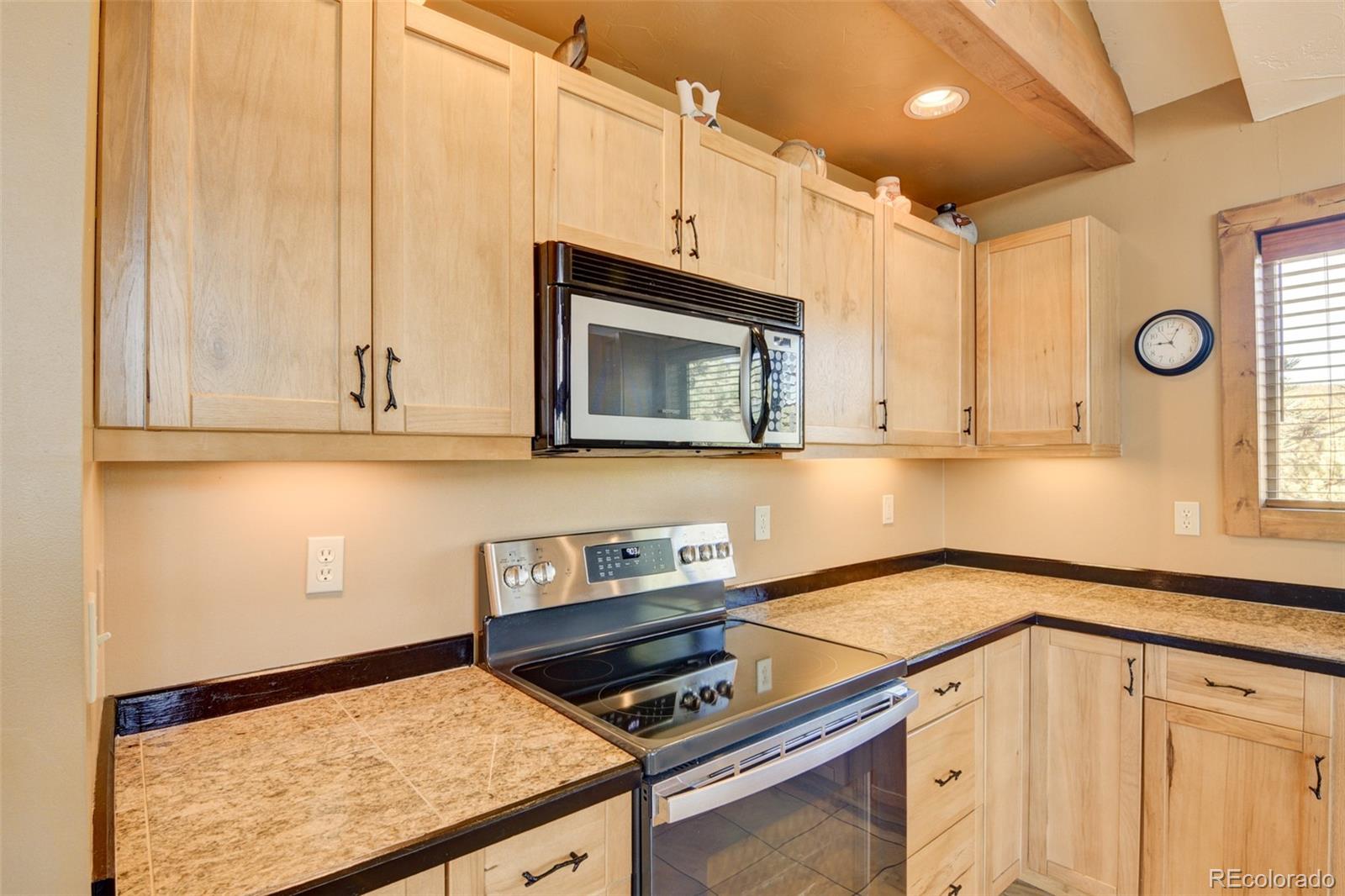 3296 Singletree Road Hartsel, CO 80449 - Photo 26 of 50 a kitchen with a sink and cabinets