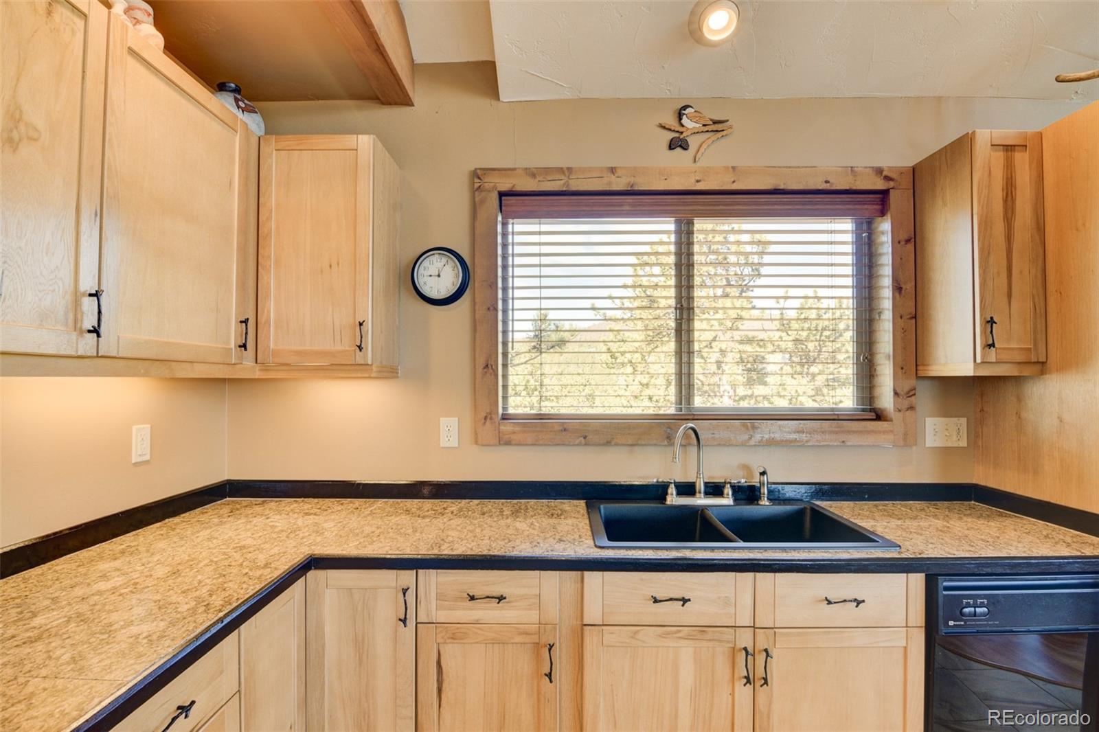 3296 Singletree Road Hartsel, CO 80449 - Photo 27 of 50 a kitchen with granite countertop a sink and a window