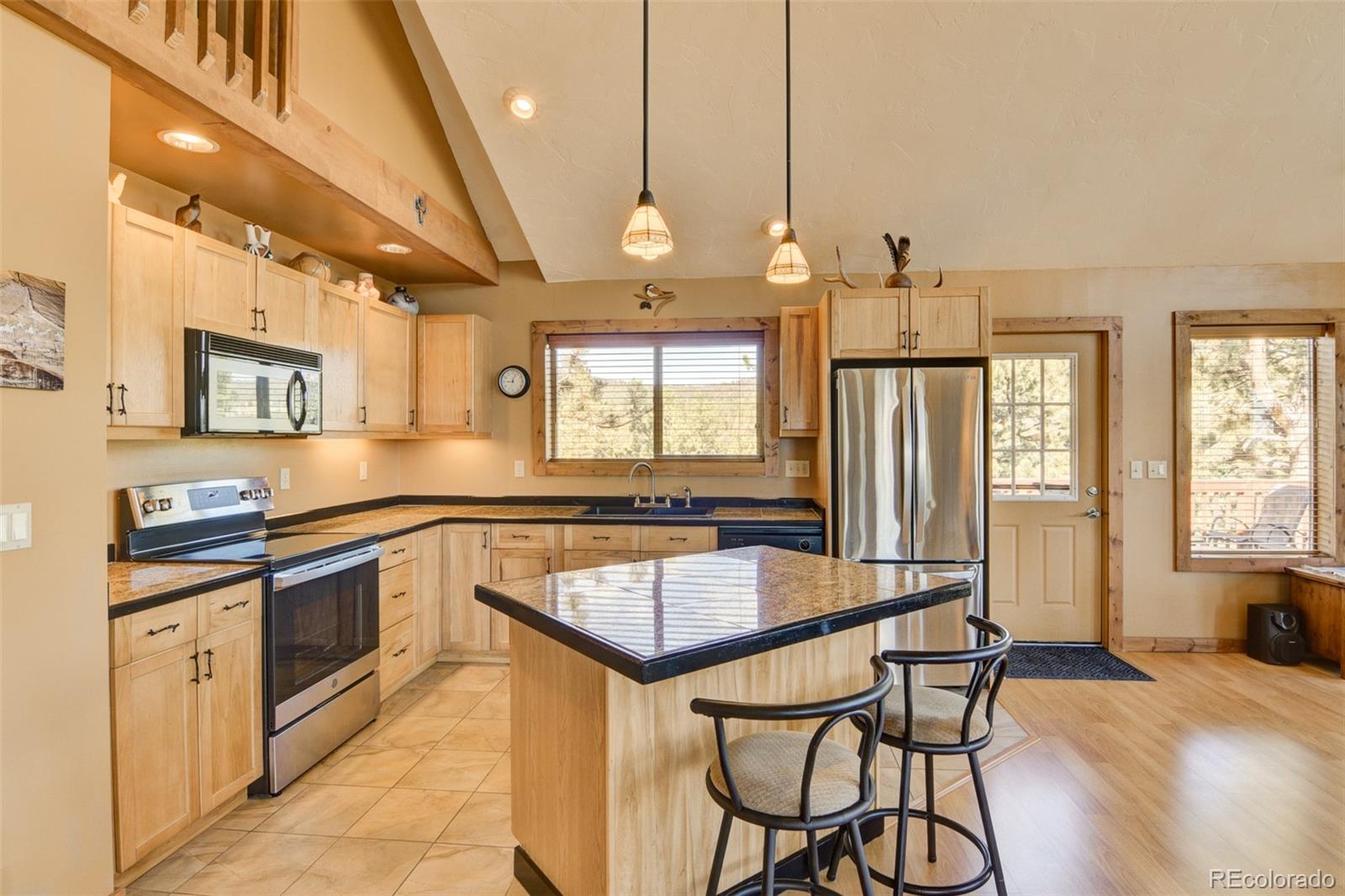 3296 Singletree Road Hartsel, CO 80449 - Photo 28 of 50 a kitchen with granite countertop a sink appliances cabinets and furniture