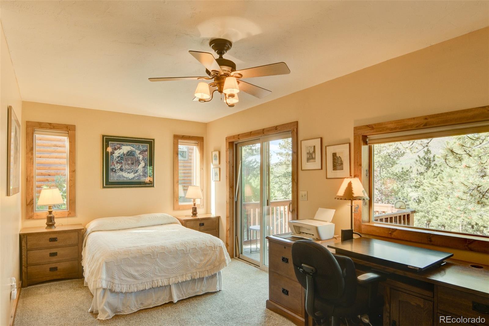 3296 Singletree Road Hartsel, CO 80449 - Photo 29 of 50 a bedroom with a bed and a large window