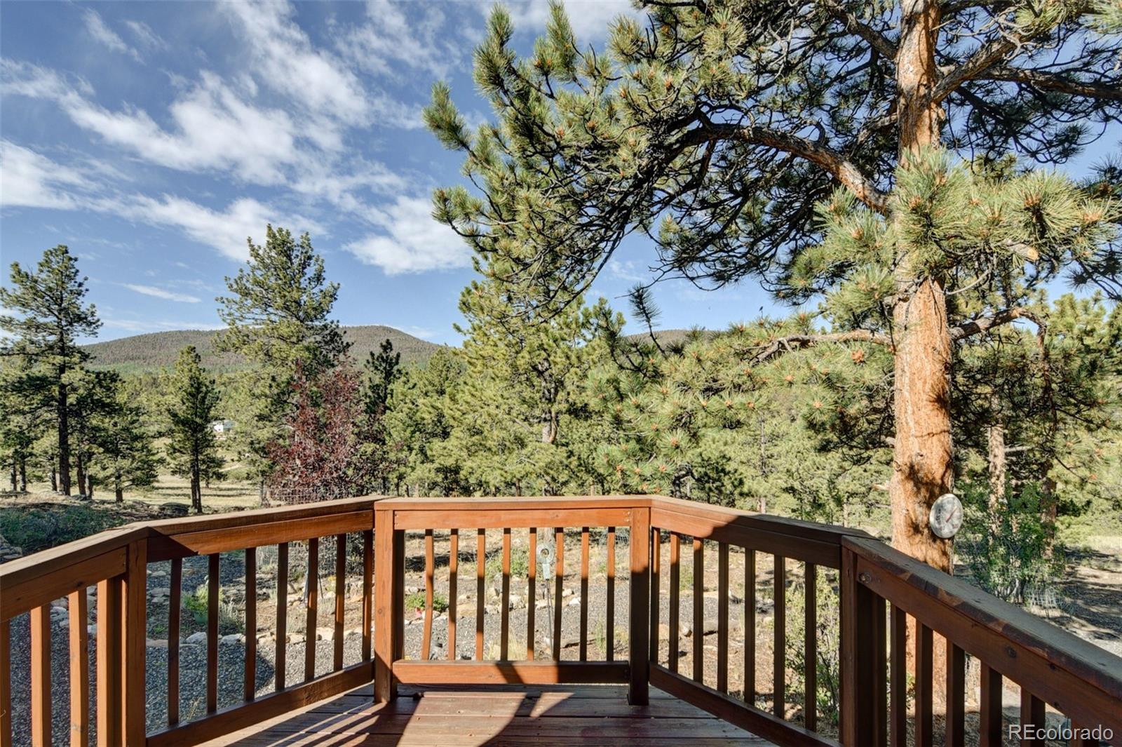 3296 Singletree Road Hartsel, CO 80449 - Photo 32 of 50 a balcony with wooden floor and fence