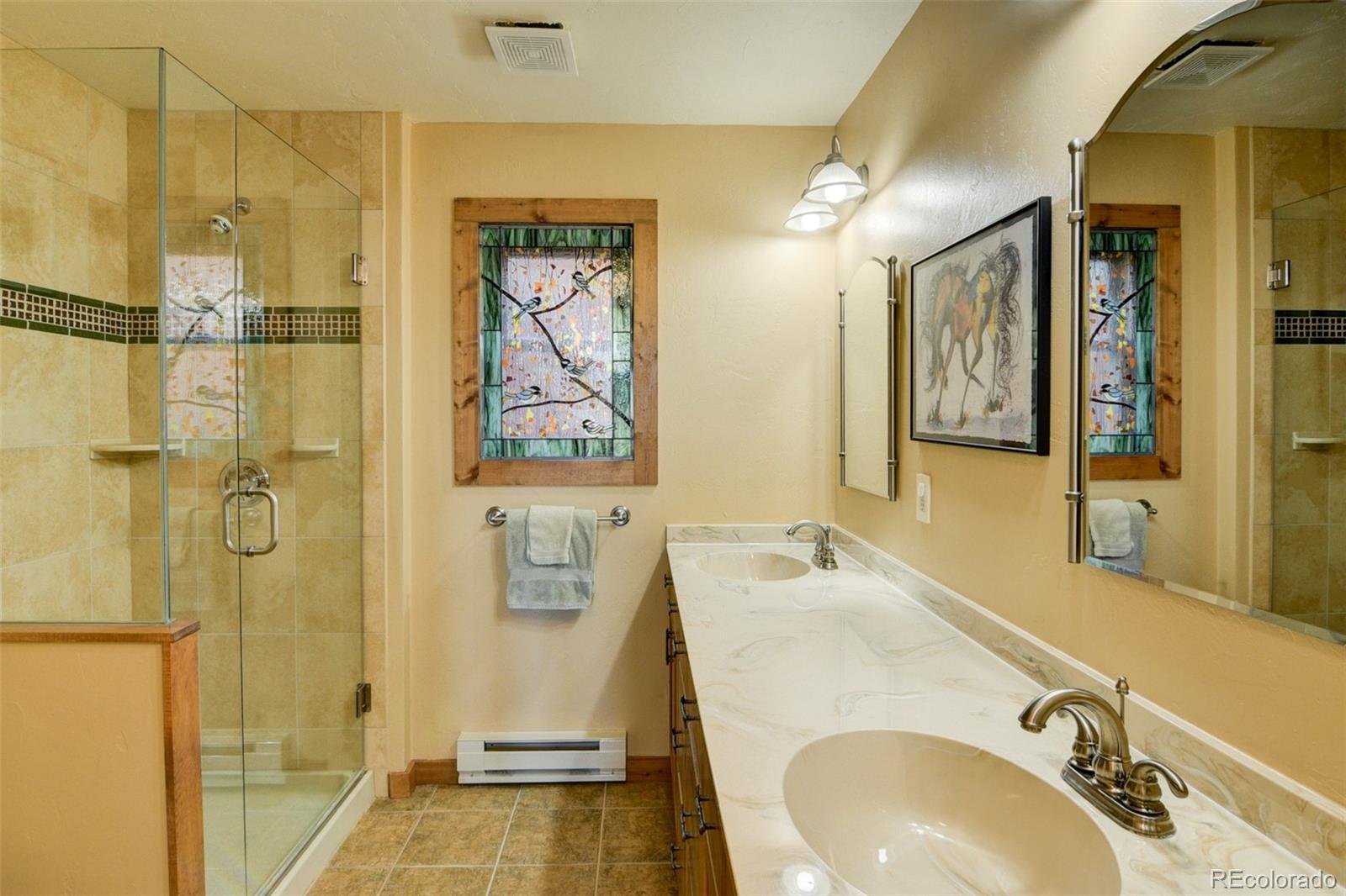 3296 Singletree Road Hartsel, CO 80449 - Photo 33 of 50 a bathroom with a sink and a mirror
