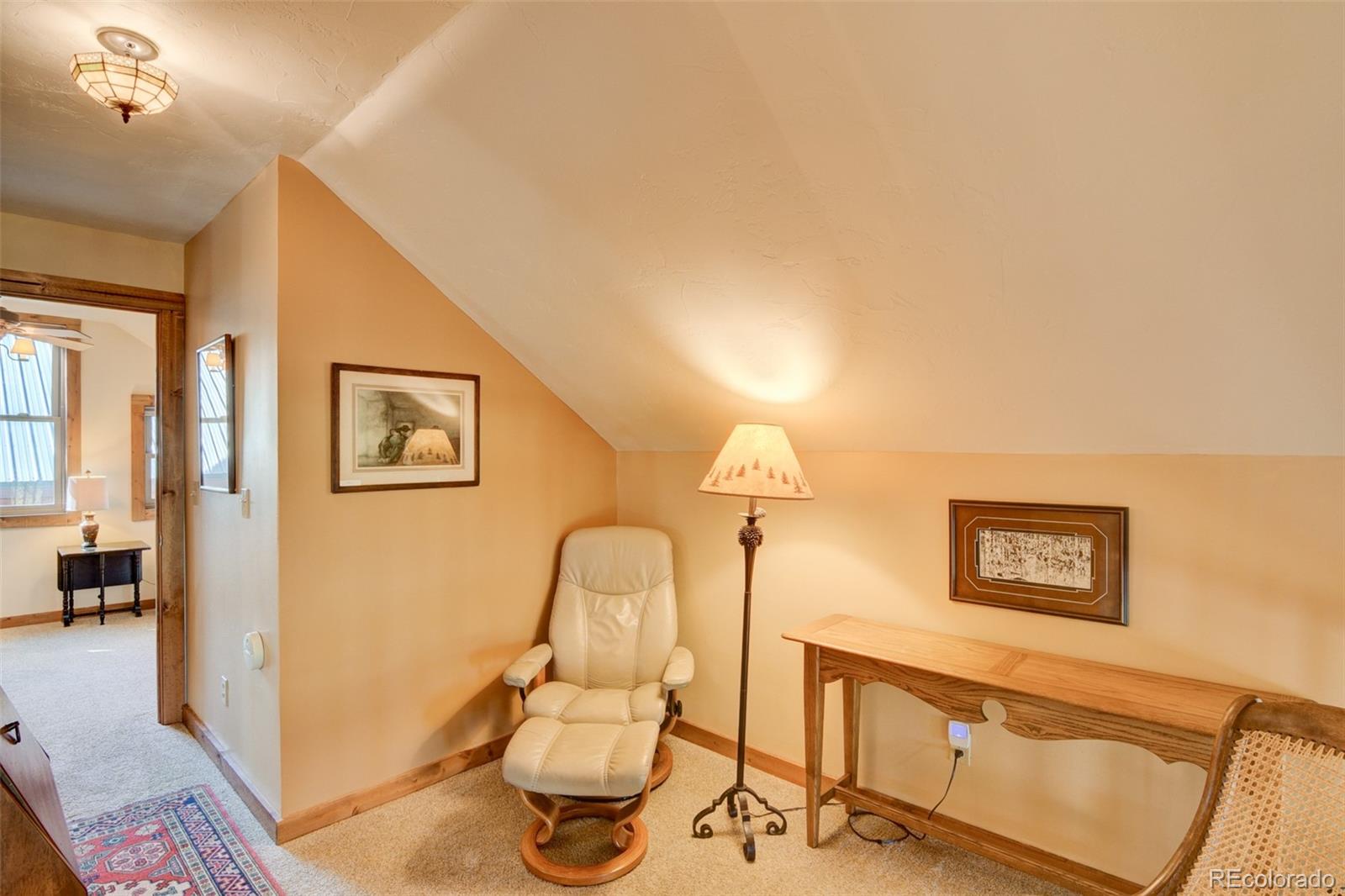 3296 Singletree Road Hartsel, CO 80449 - Photo 38 of 50 a living room with furniture and a painting on the wall