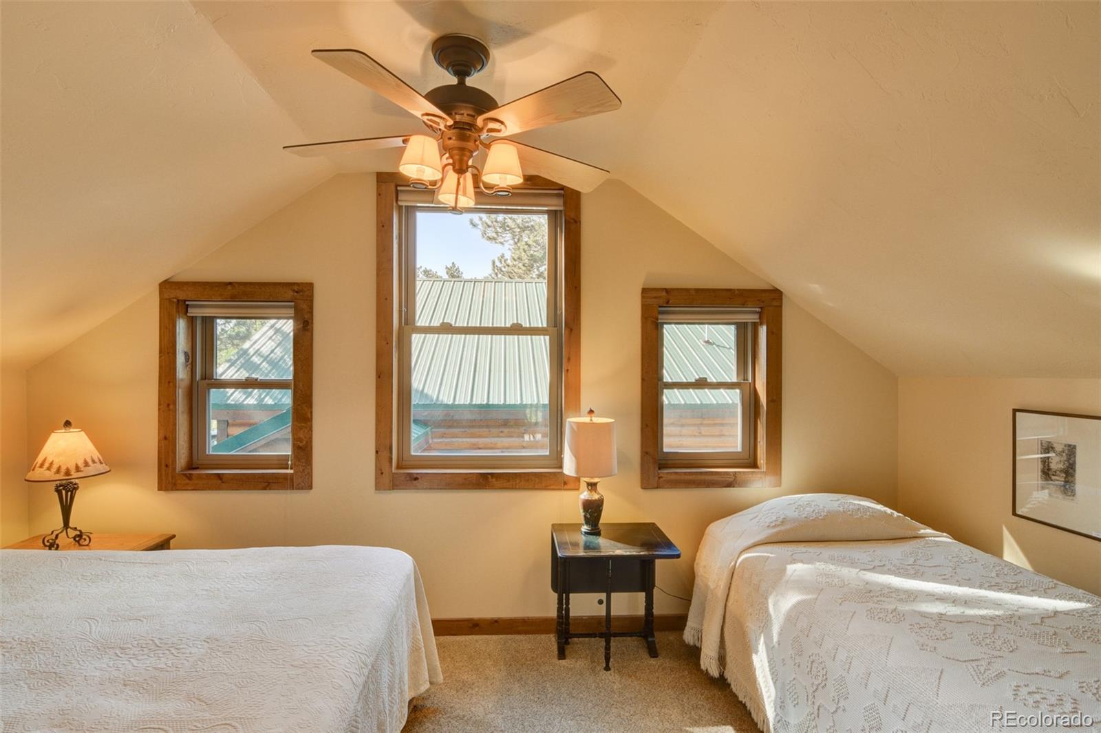 3296 Singletree Road Hartsel, CO 80449 - Photo 39 of 50 a bedroom with a bed and a chandelier