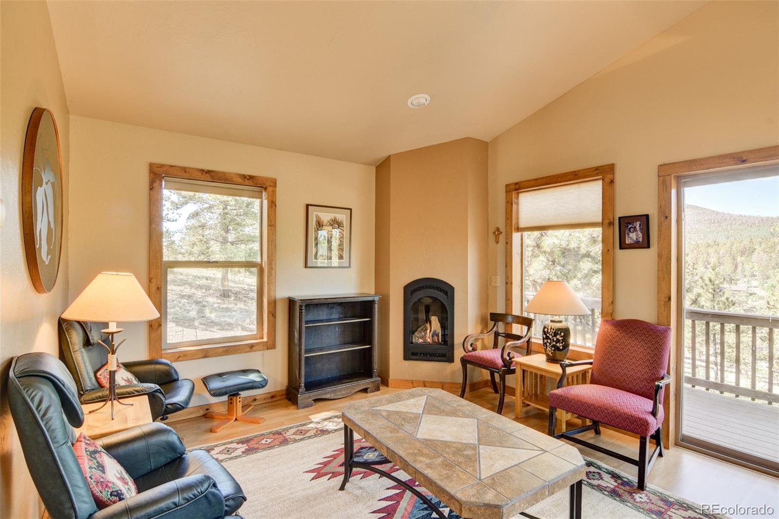 3296 Singletree Road Hartsel, CO 80449 - Photo 42 of 50 a living room with fireplace furniture and a large window