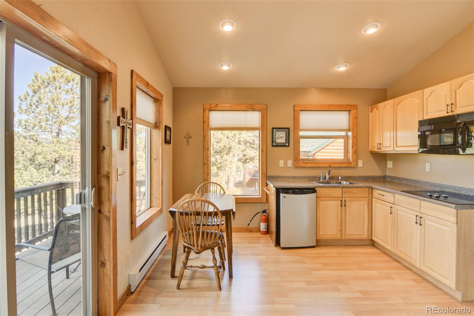 3296 Singletree Road Hartsel, CO 80449 - Photo 43 of 50 a kitchen with a table chairs sink and cabinets