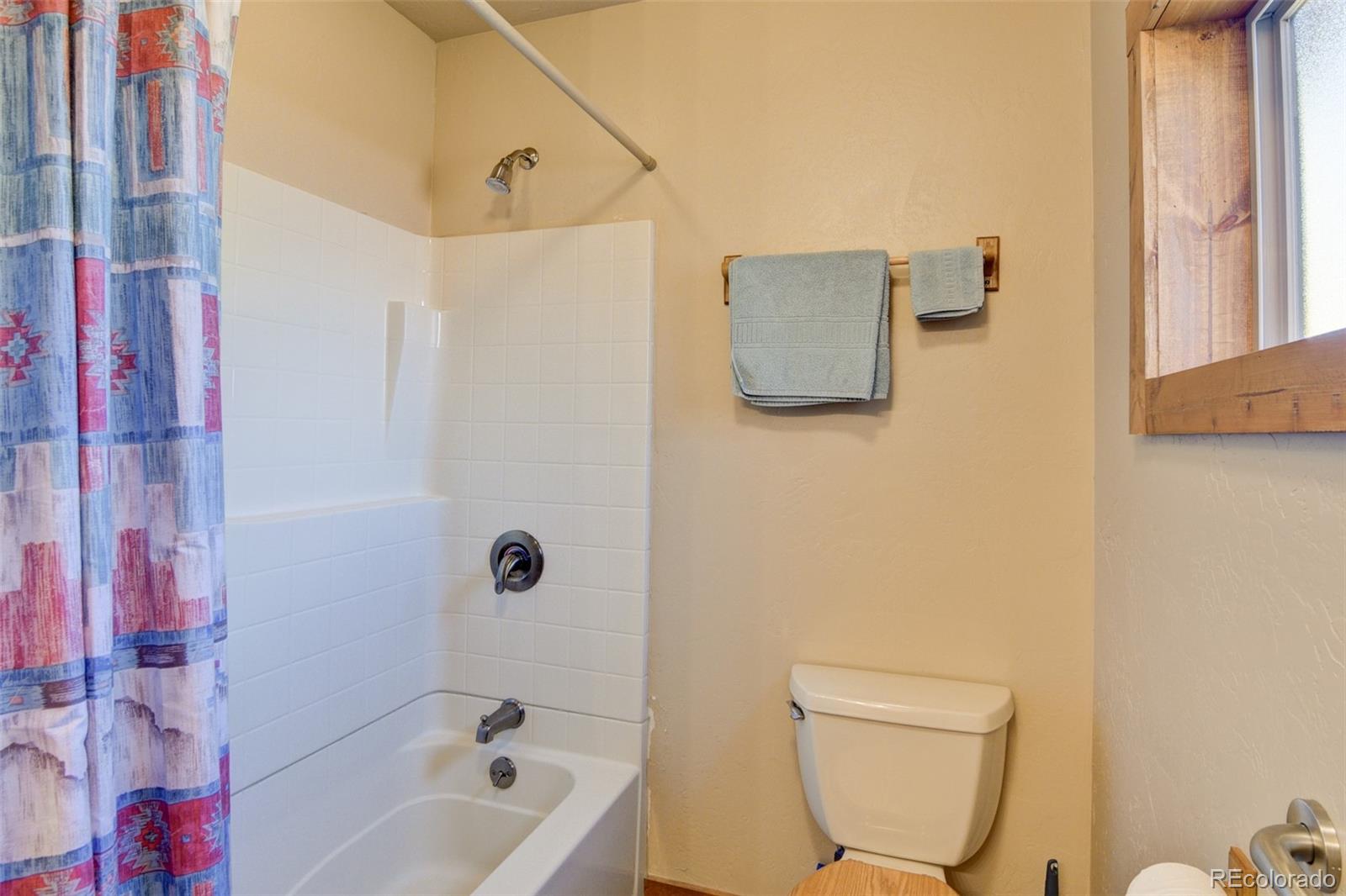 3296 Singletree Road Hartsel, CO 80449 - Photo 47 of 50 a bathroom with a bathtub and a shower
