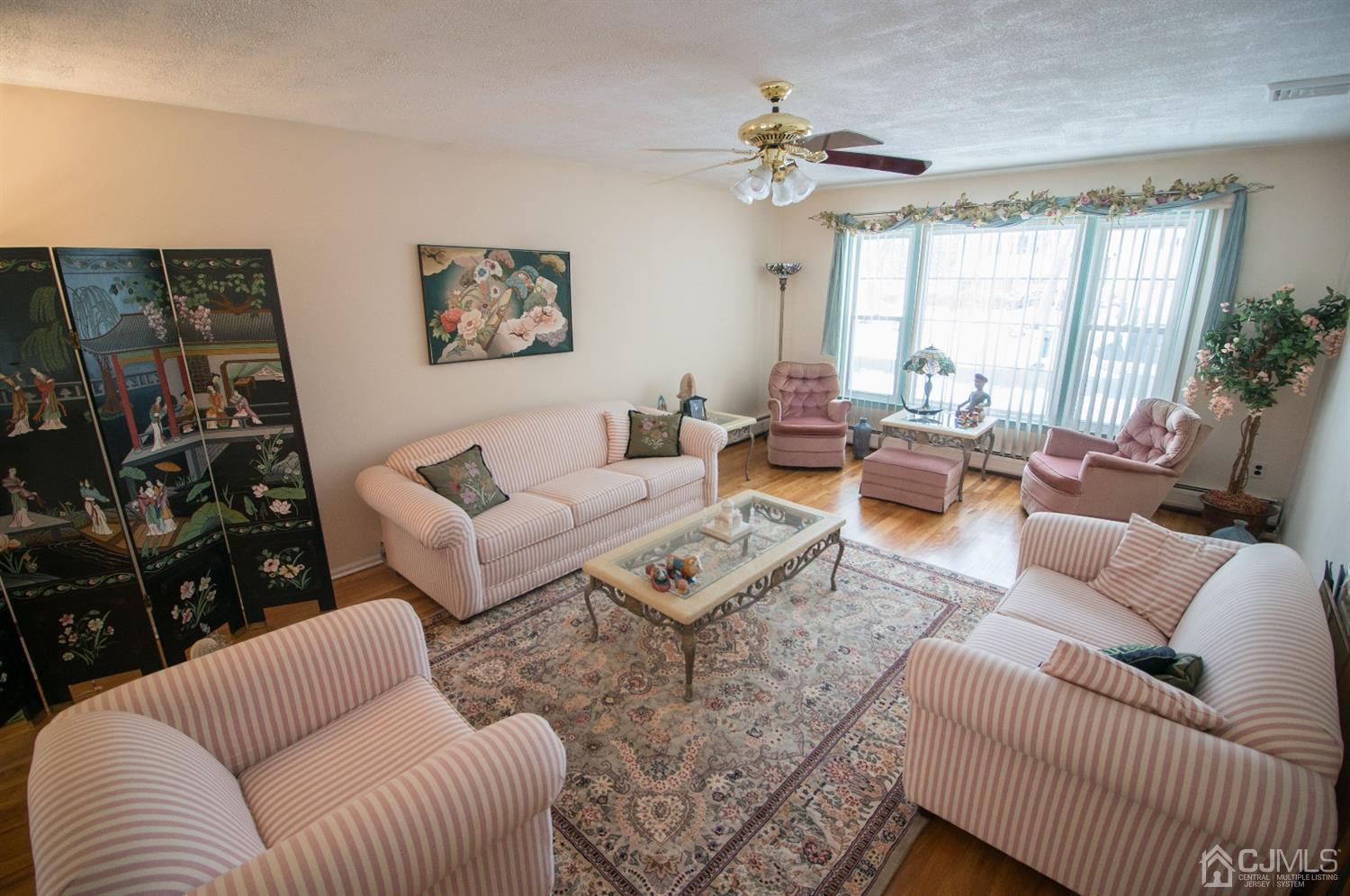 9 Library Place Edison, NJ 08820 - Photo 11 of 44 a living room with furniture a chandelier and a window
