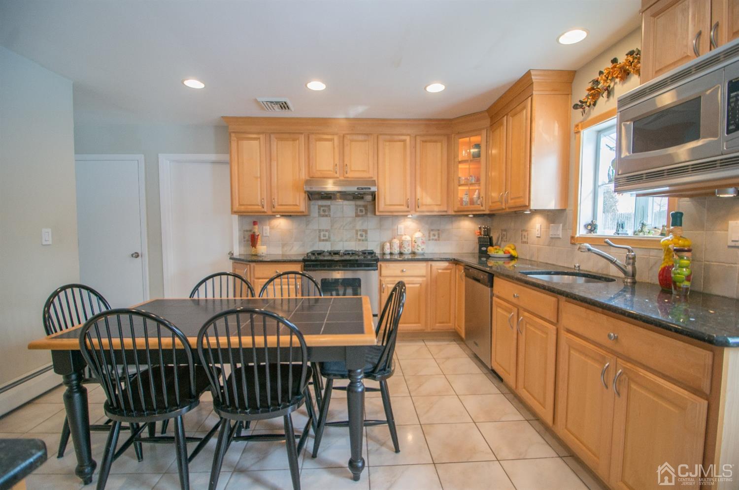 9 Library Place Edison, NJ 08820 - Photo 16 of 44 a kitchen with granite countertop lots of wooden cabinets a sink and appliances