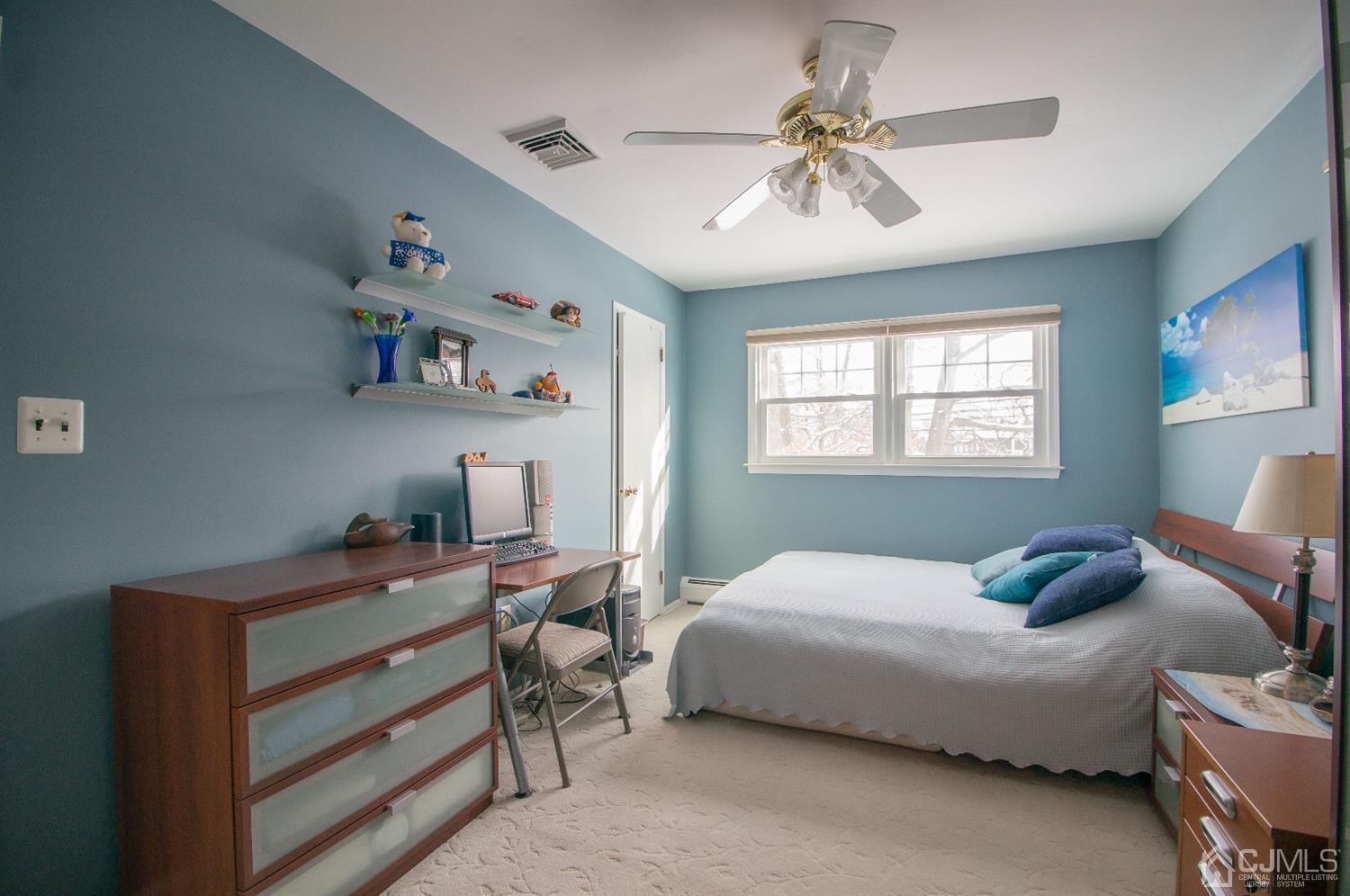 9 Library Place Edison, NJ 08820 - Photo 29 of 44 a bedroom with a bed and a chandelier
