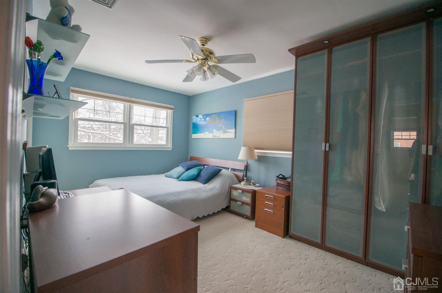 9 Library Place Edison, NJ 08820 - Photo 30 of 44 a bed room with a bed and a chandelier