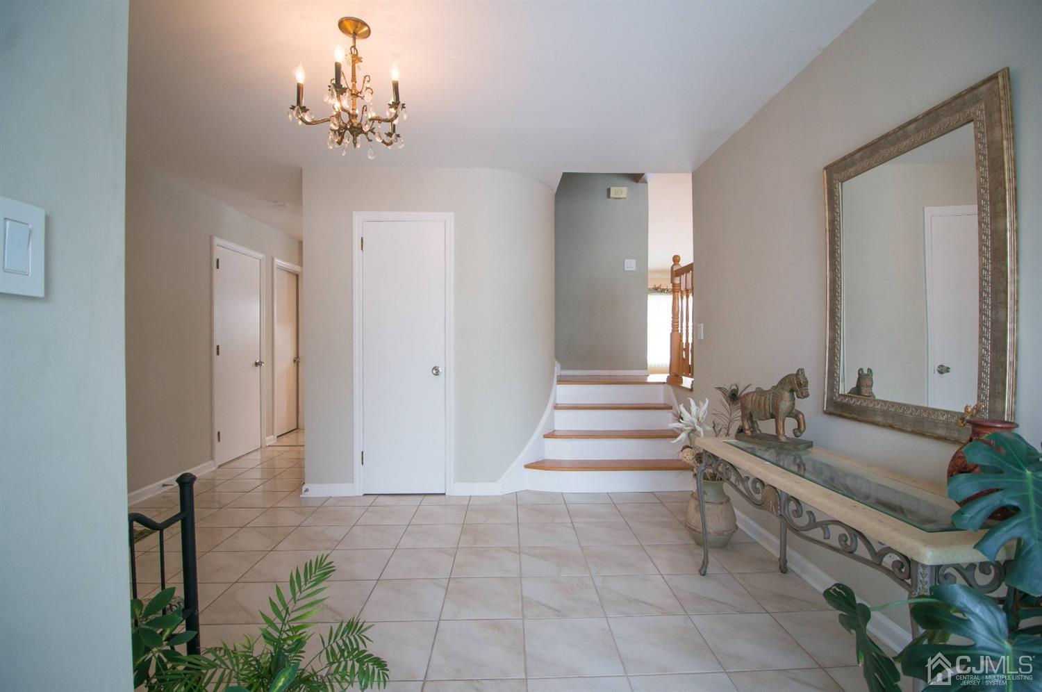 9 Library Place Edison, NJ 08820 - Photo 4 of 44 a spacious bathroom with a granite countertop sink a mirror and a bathtub