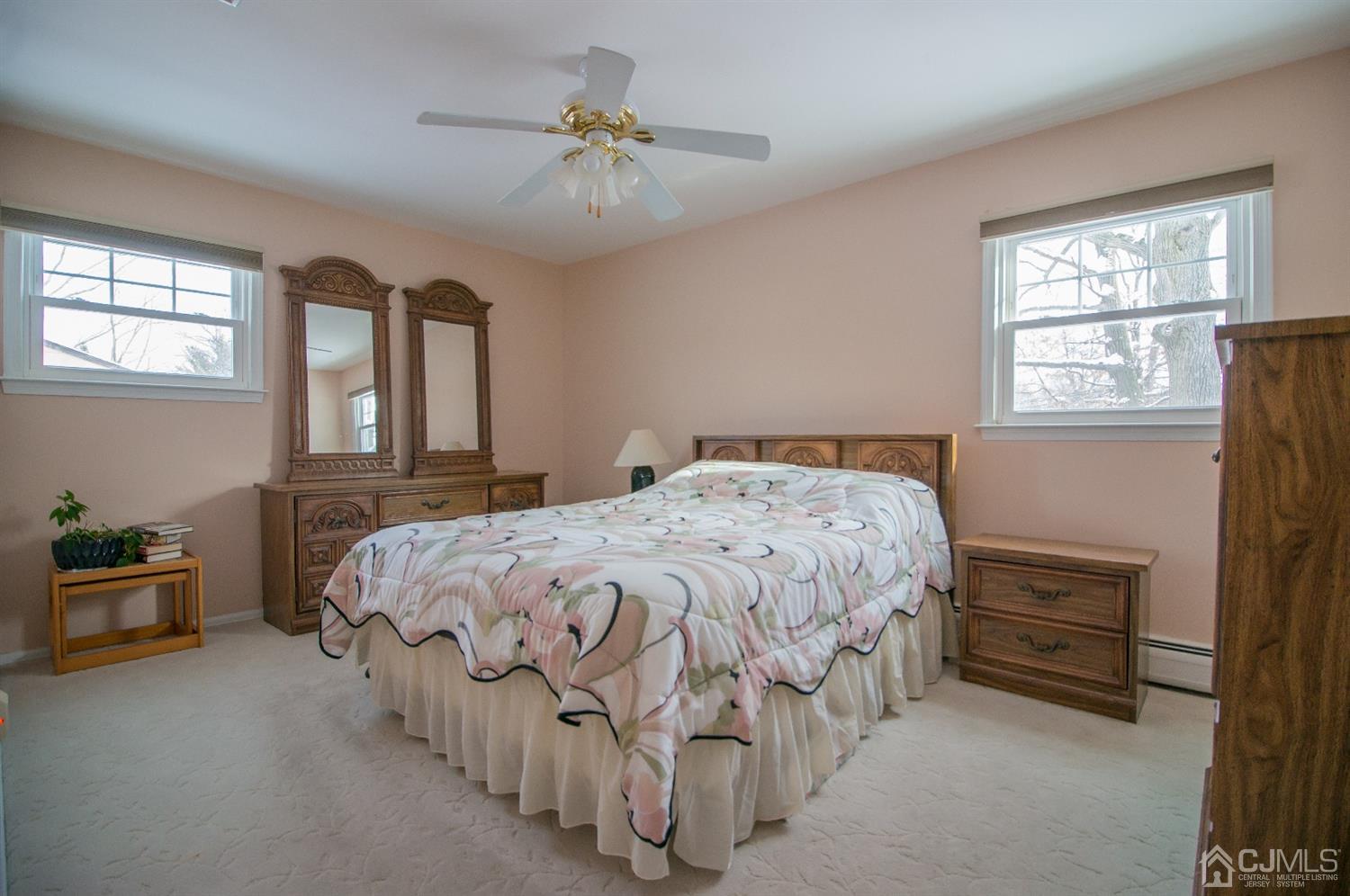 9 Library Place Edison, NJ 08820 - Photo 31 of 44 a bedroom with a bed a chandelier and a window