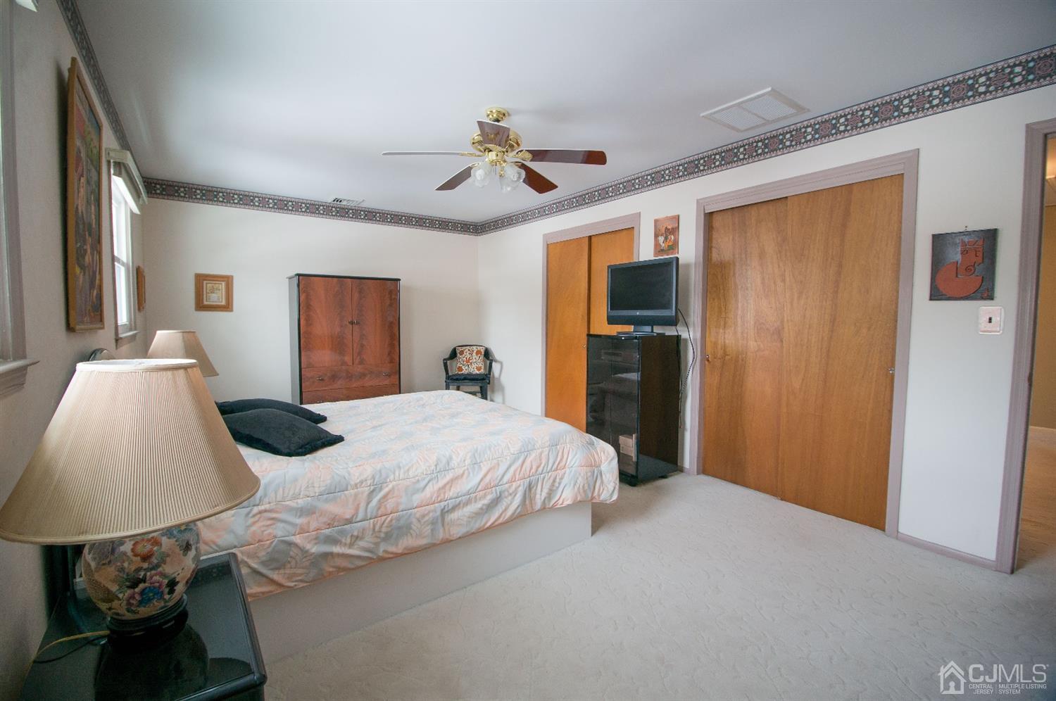 9 Library Place Edison, NJ 08820 - Photo 36 of 44 a bedroom with a bed and a chandelier