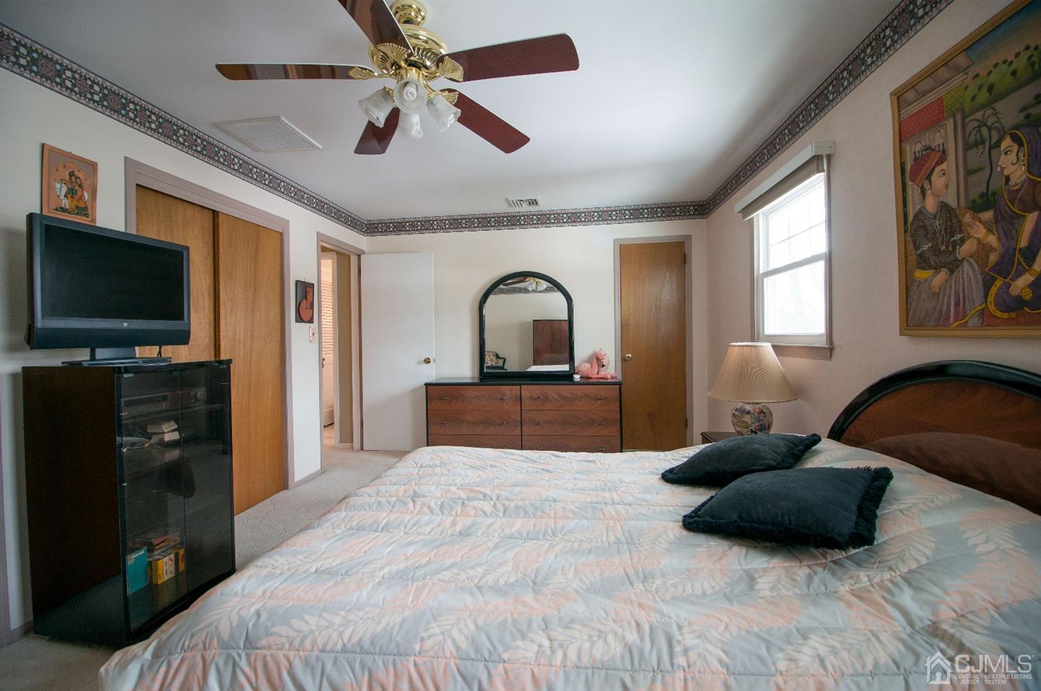 9 Library Place Edison, NJ 08820 - Photo 37 of 44 a bedroom with a bed and a flat screen tv