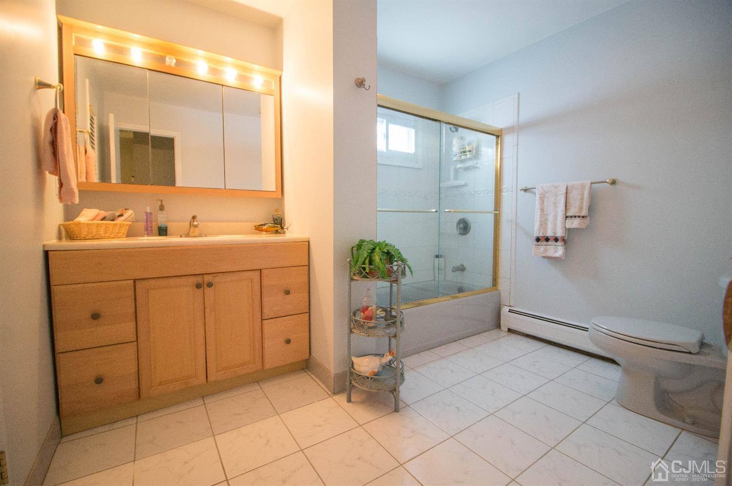 9 Library Place Edison, NJ 08820 - Photo 40 of 44 a spacious bathroom with a double vanity sink toilet and shower