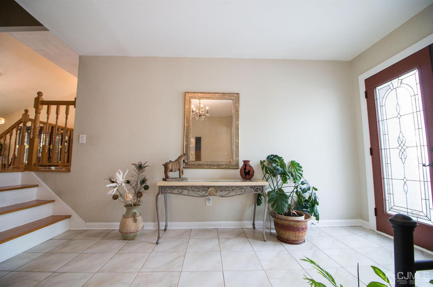 9 Library Place Edison, NJ 08820 - Photo 6 of 44 a living room with a potted plant and open kitchen view