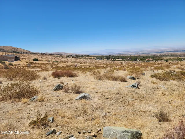 a view of a road with a snow in the background