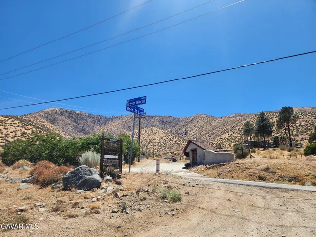 a view of a large building with mountains in the background