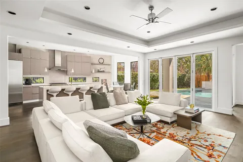 a kitchen with a dining table chairs refrigerator and cabinets