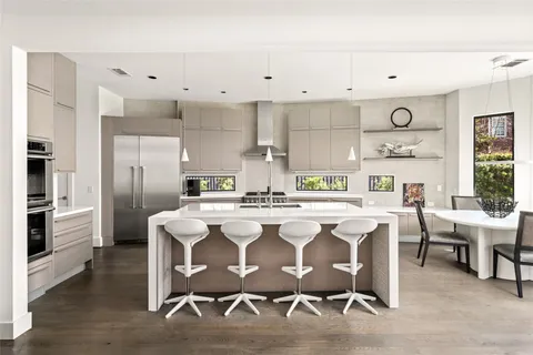 a kitchen with white cabinets and appliances