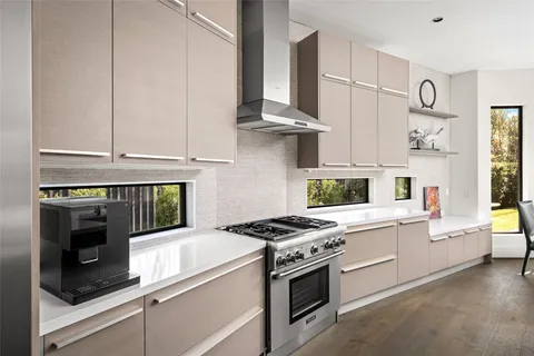 a living room with furniture a flat screen tv and a large window