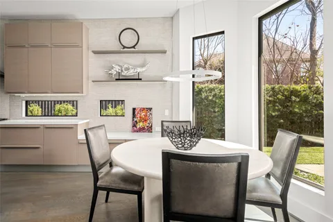 a dining room with furniture and a large window