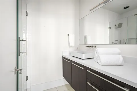 a bedroom with a bed and a mirror