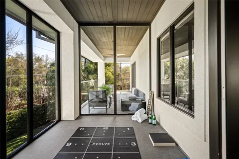 a view of a porch with furniture and a yard