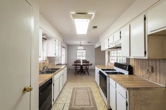 a bathroom with a granite countertop double vanity sink and mirror
