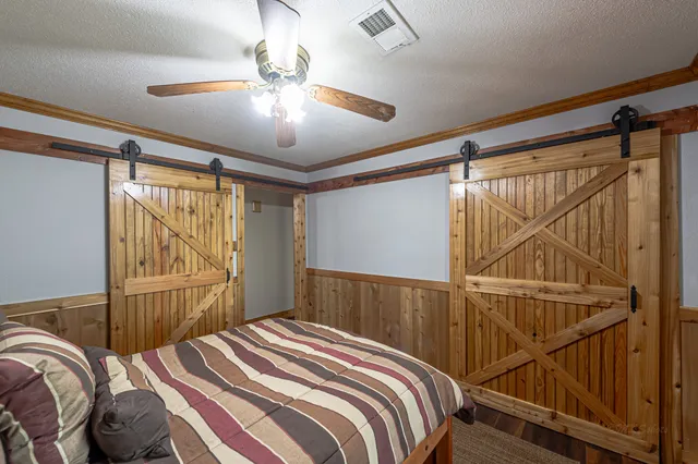 a view of pool with a big yard and large trees