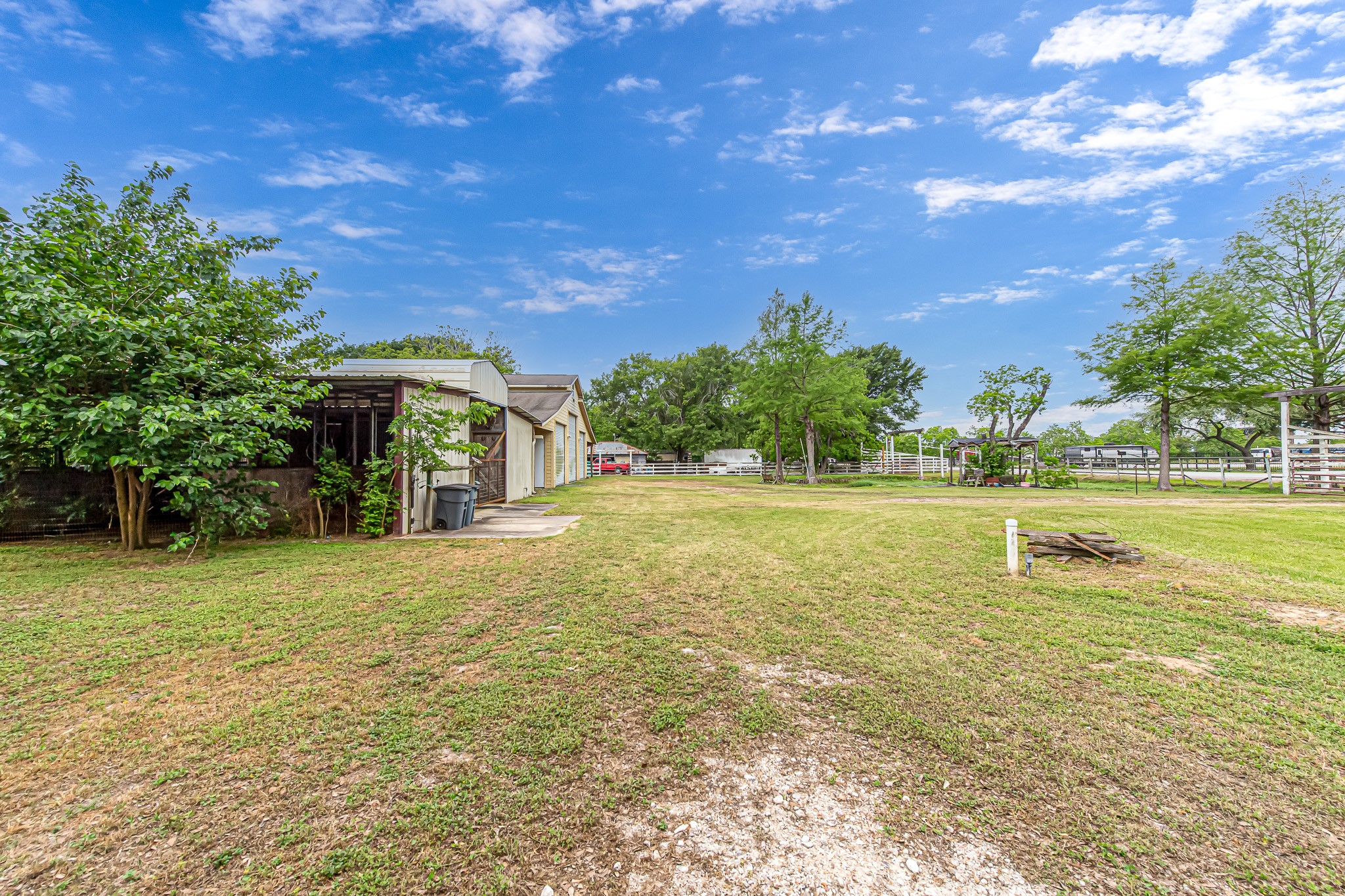 29519 Marti Road Katy, TX 77493 - Photo 31 of 46 Wide open road frontage with horse stalls and workshop to the left.