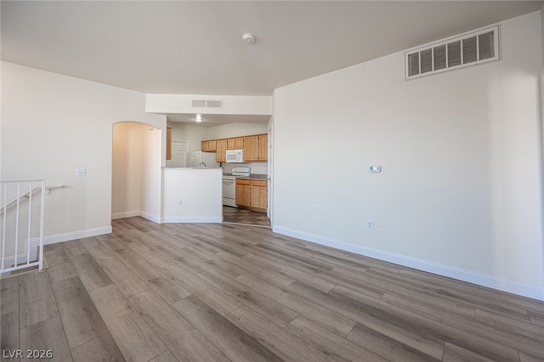 8555 West Russell Road, Unit 2062 Las Vegas, NV 89113 - Photo 12 of 35 An inviting open-concept layout connects the well-lit living area to a practical kitchen.