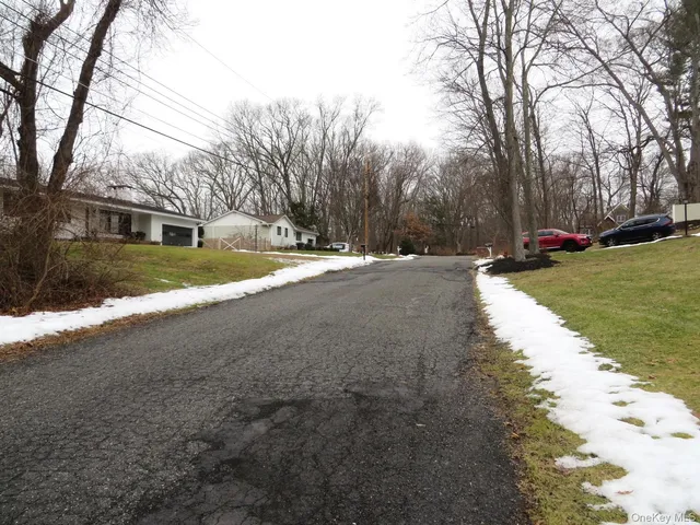 a view of a house with a yard covered with snow