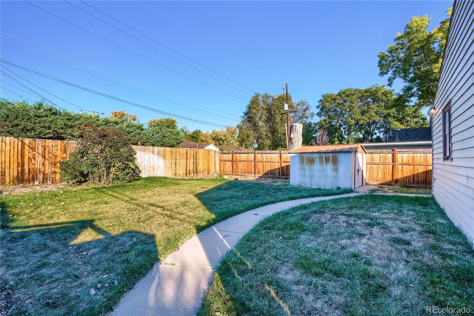 4685 Pierce Street Wheat Ridge, CO 80033 - Photo 23 of 26 a view of a backyard with large trees
