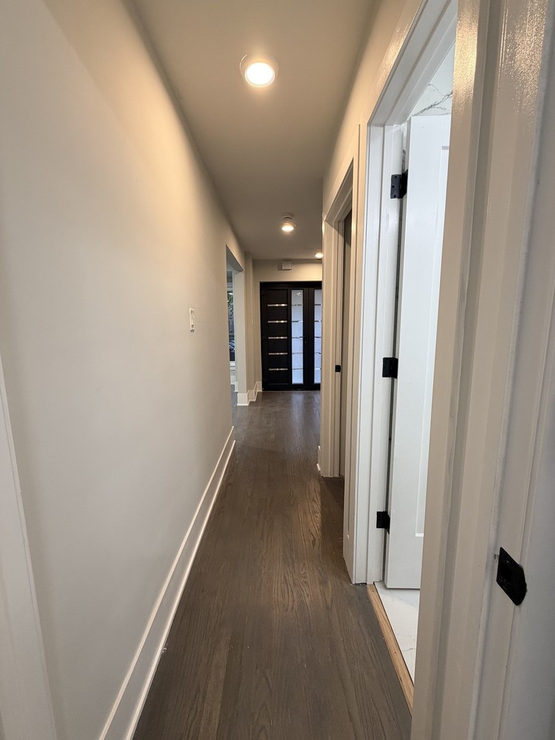 3024 West Fargo Avenue Chicago, IL 60645 - Photo 17 of 38 a view of a hallway with wooden floor and staircase