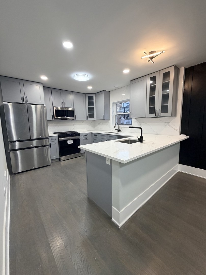 3024 West Fargo Avenue Chicago, IL 60645 - Photo 5 of 38 a kitchen with stainless steel appliances granite countertop a refrigerator and a sink