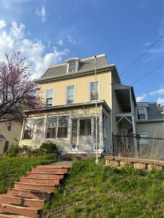 a front view of a house with garden