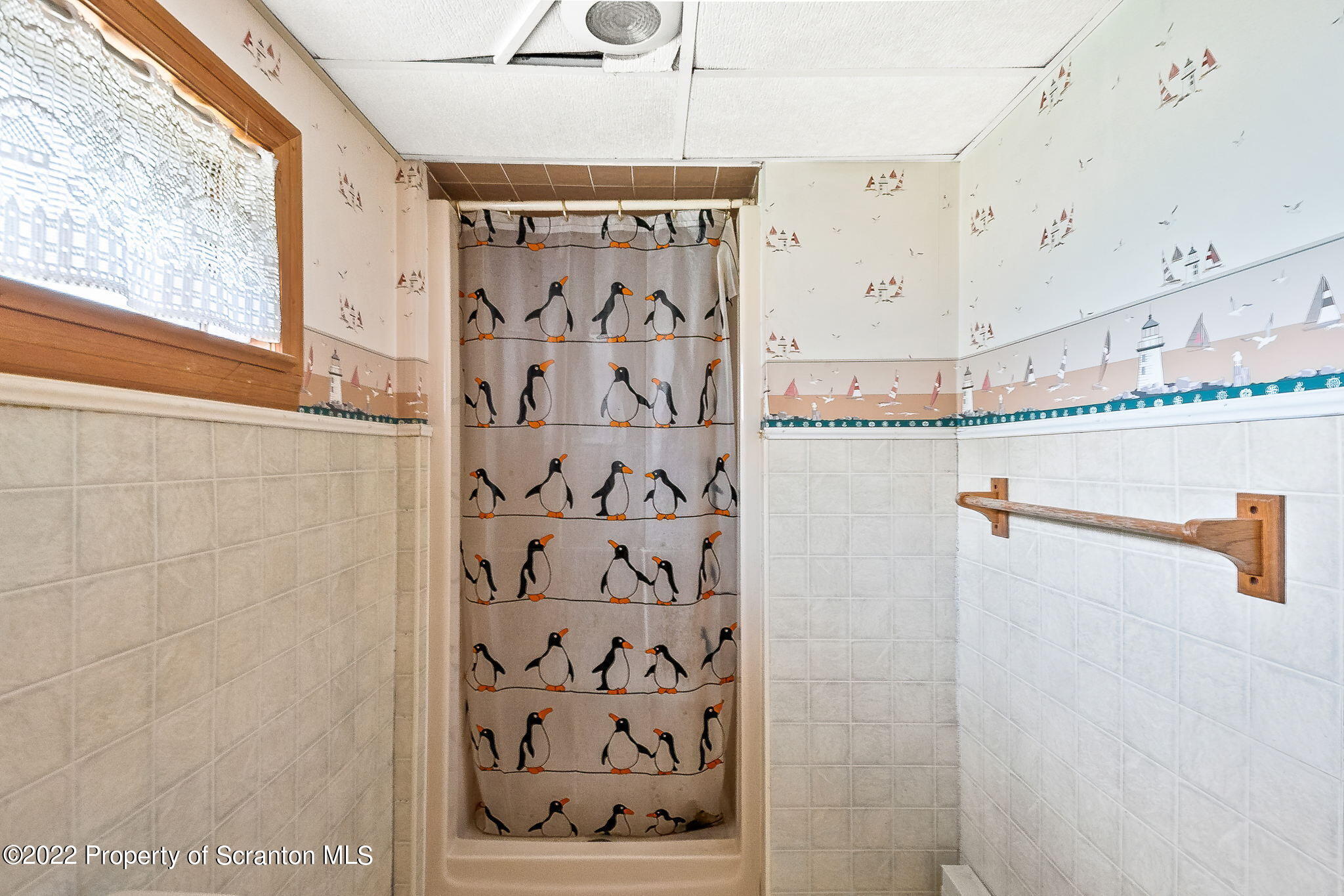 423 Fairview Road Dalton, PA 18414 - Photo 19 of 21 a view of a bathroom with a shower and a window