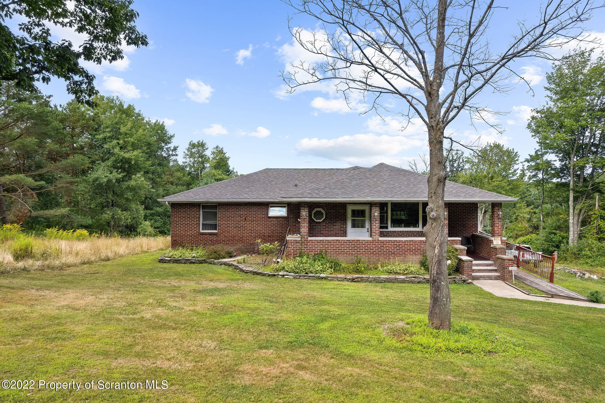 423 Fairview Road Dalton, PA 18414 - Photo 21 of 21 a front view of house with yard and trees