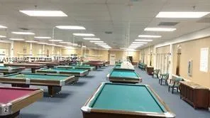 a room with pool table and lots of furniture