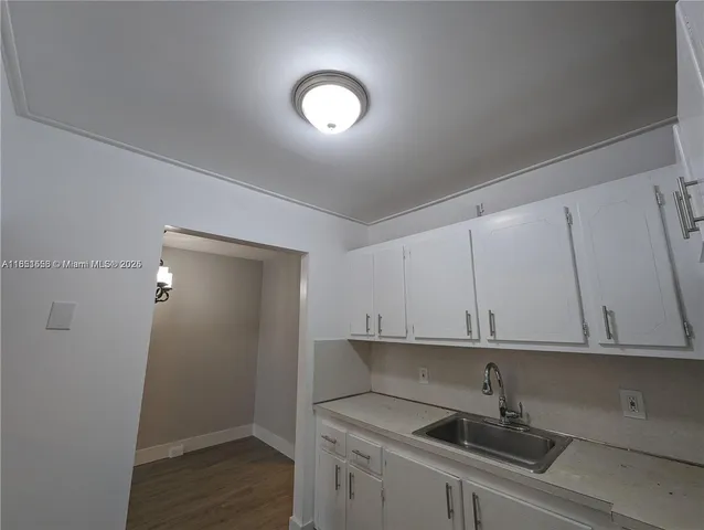 a kitchen with a sink and cabinets