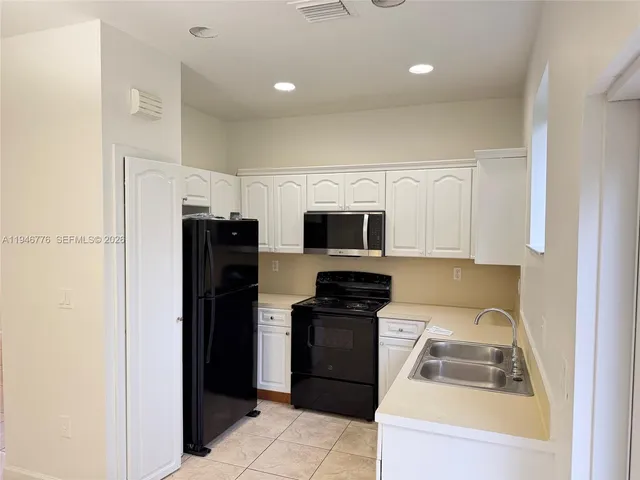 a kitchen with stainless steel appliances a refrigerator stove microwave and sink