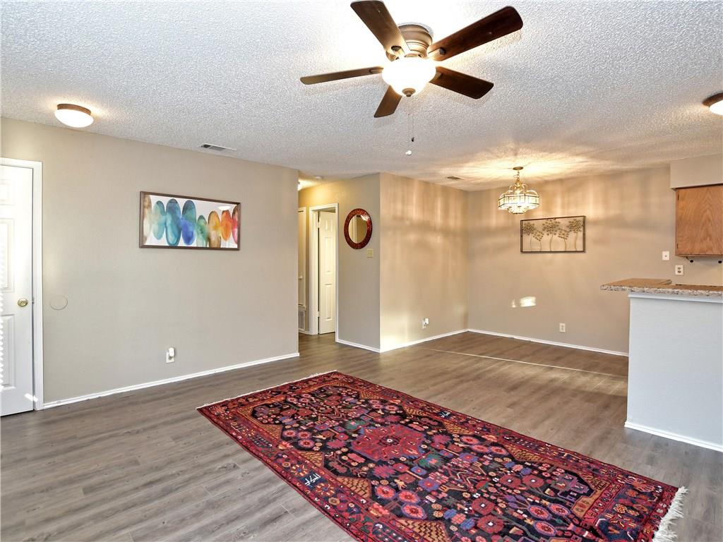 5401 Spring Meadow Road, Unit B Austin, TX 78744 - Photo 4 of 21 An inviting open-concept living space features warm flooring and versatile lighting.