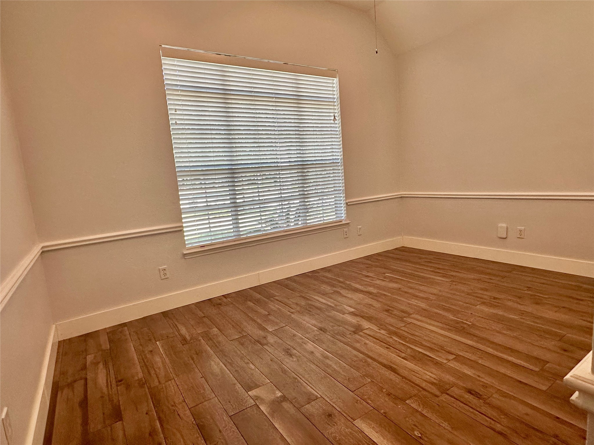 18 South Willow Point Circle Spring, TX 77382 - Photo 16 of 27 a view of an empty room with wooden floor and a window