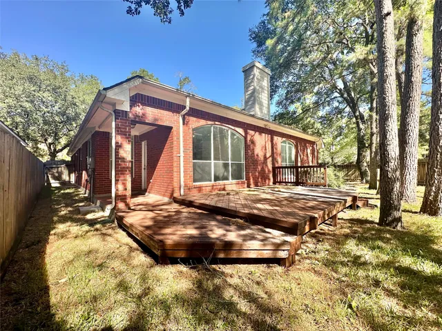 a view of house with yard and sitting area